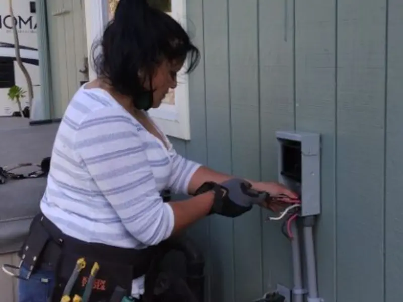 Licensed electrician wiring an exterior subpanel in Plant City